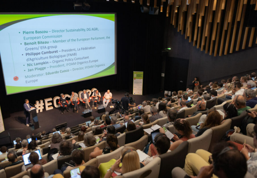 Audience facing speaker and screen at European Organic Congress