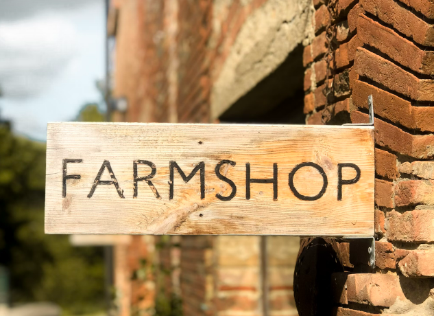 Sign shown outside a farm shop where fresh potatoes sold