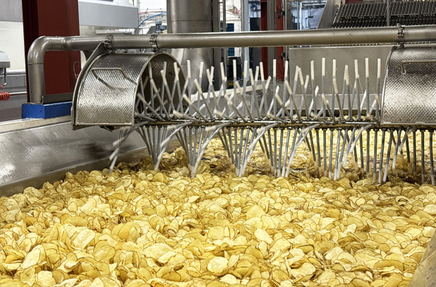 industrial fryer with potato crisps in