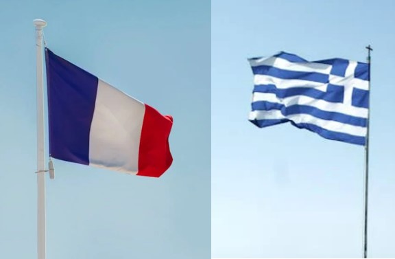 French and Greek flags on blue sky background