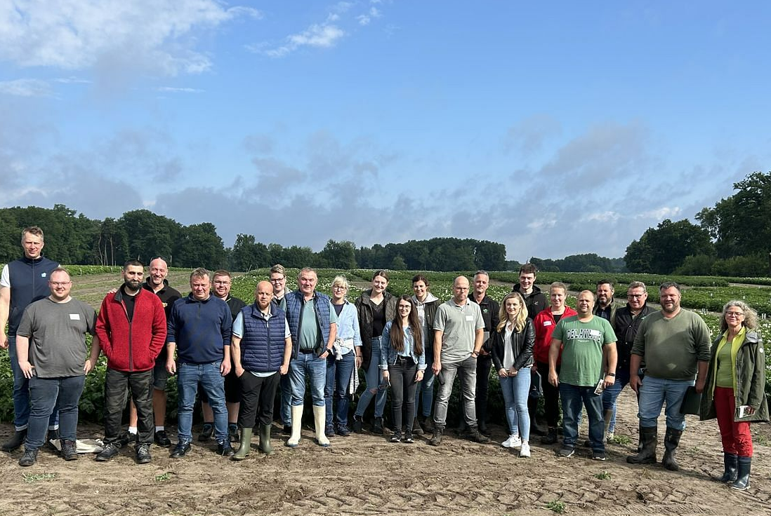 crowd of people in wellies in potato field