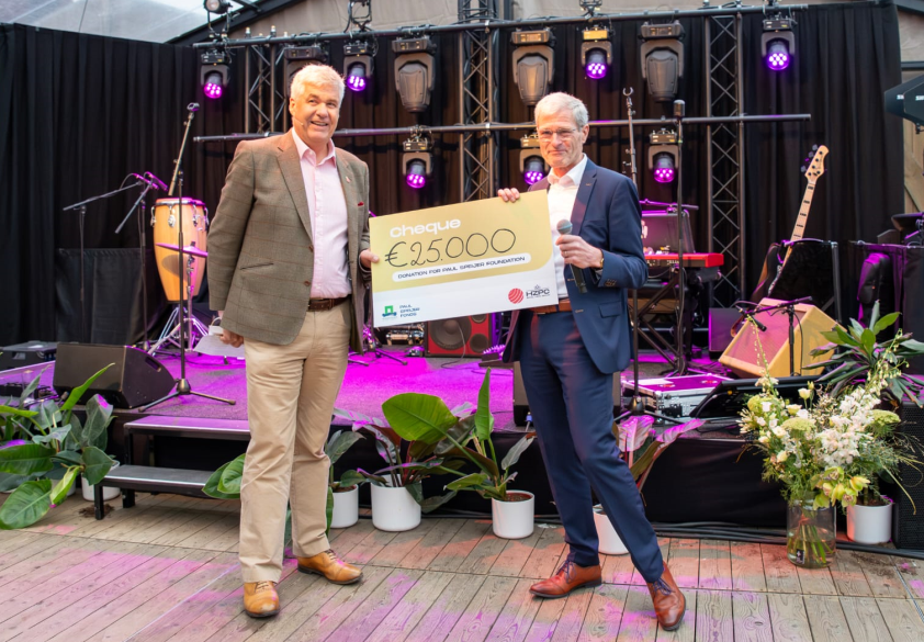 Two men holding large cheque at potato event