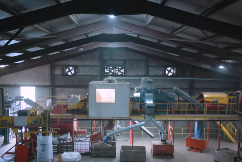Potato machinery with potatoes on inside industrial building