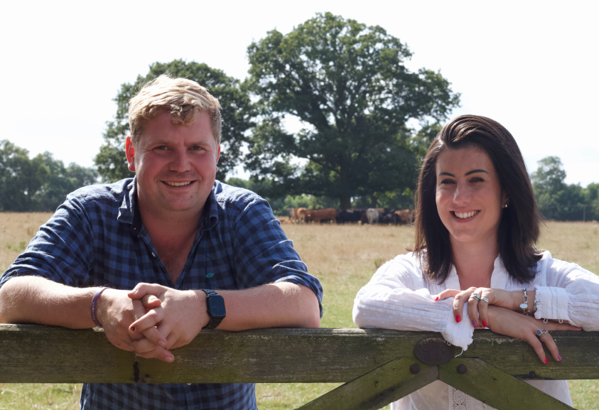 Lewis Hunter and Kate Scott leaning on farm gate