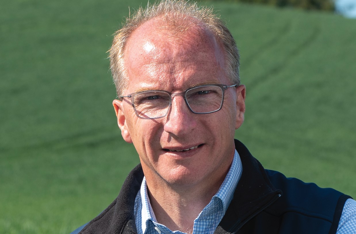 Man with glasses in gilet in field