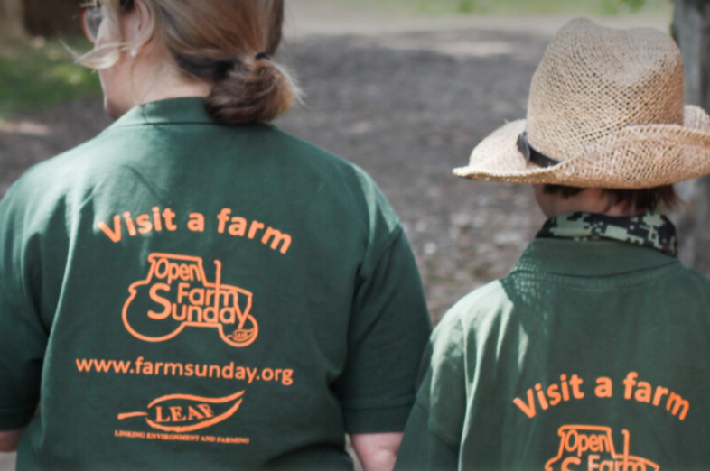 Two women wearing Open Farm Sunday branded t-shirts