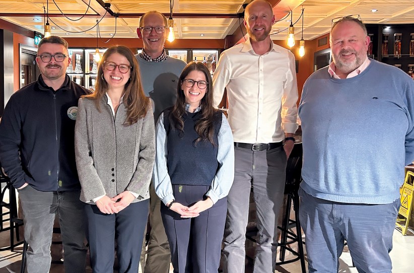 double row of people in fleece jackets and shirts