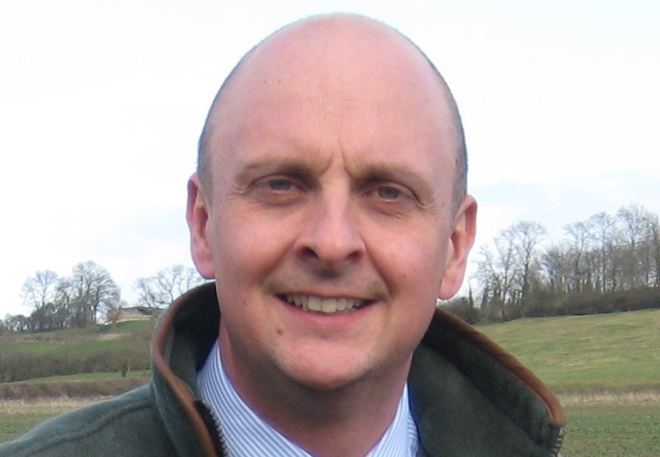 Man in fleece gilet with field in background