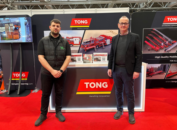 Two men standing in front of trade counter