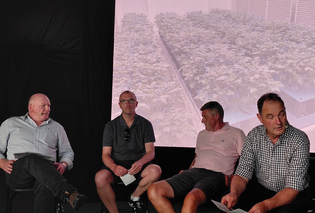 four men in front of projected image on screen
