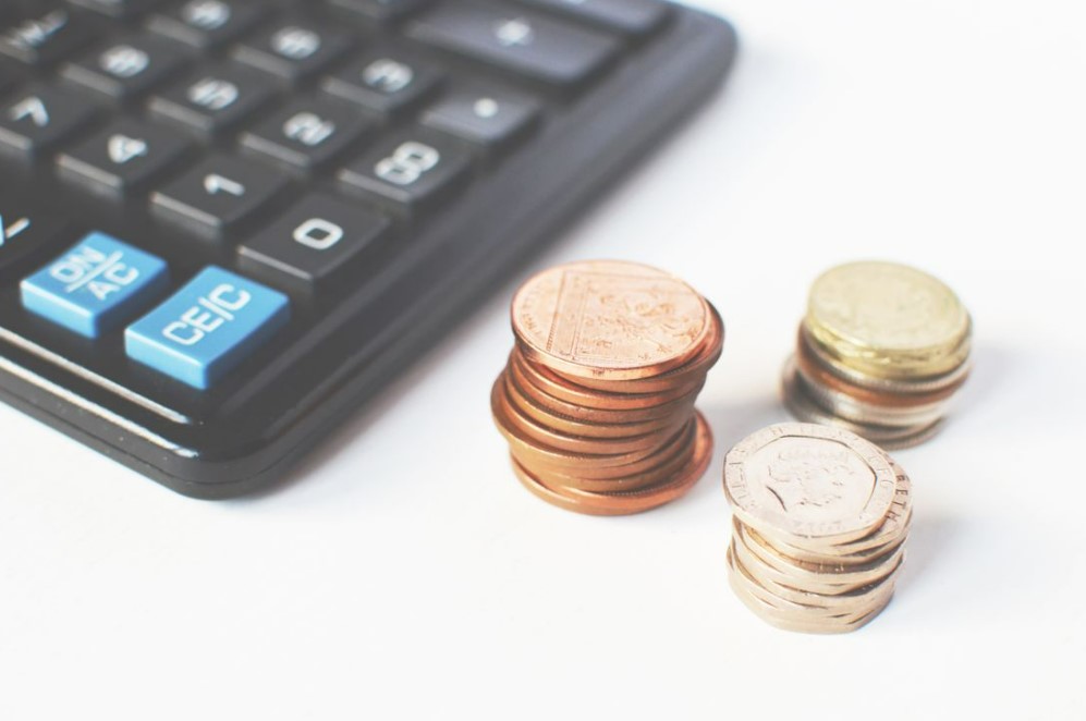 Calculator and piles of coins