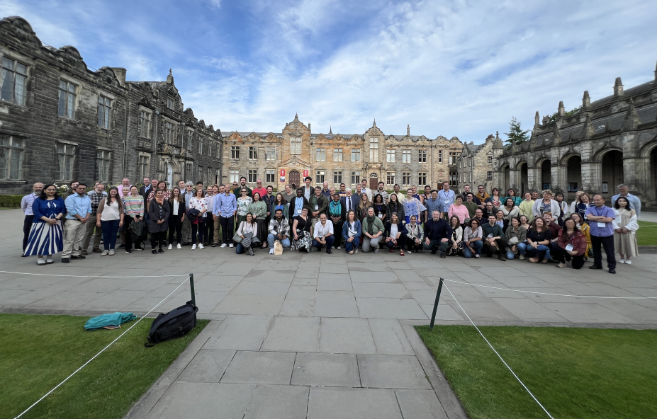 crowd of people in square surrounded by university buildings