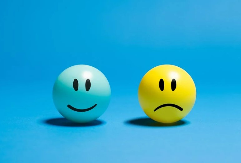 smiley face and sad face on blue background